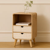 Wooden side table with two drawers and a small plant on a beige wall background
