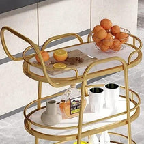 Close-up of White Marble Top on Golden Oval Trolley