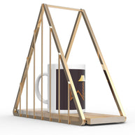 Close-up of smooth gold finish on triangle iron wall shelf