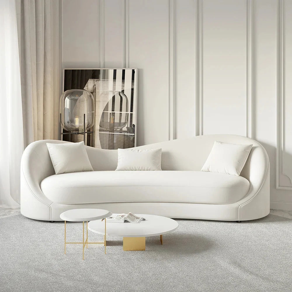 A curved-back velvet 3-seater