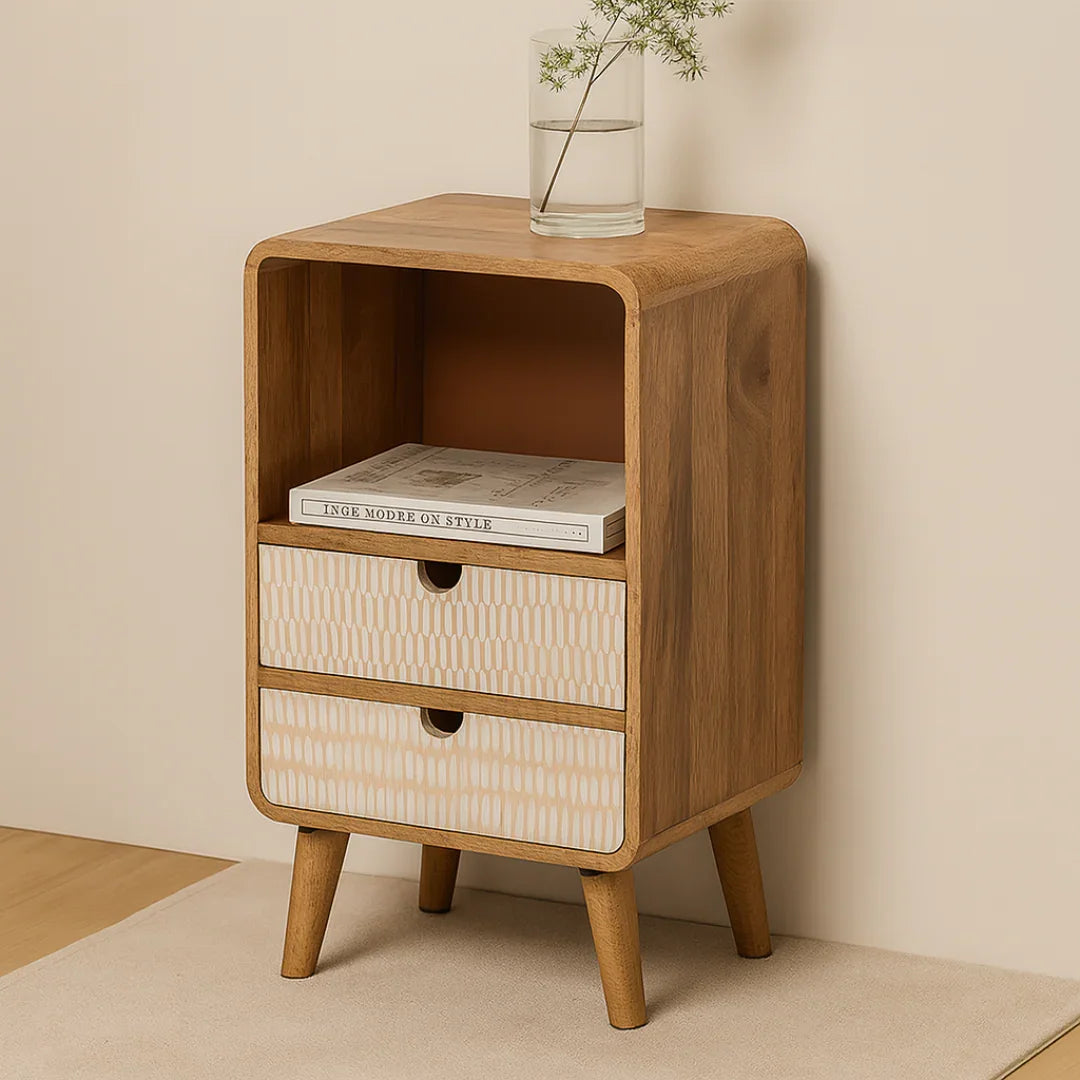 Wooden side table with a patterned drawer against a beige wall