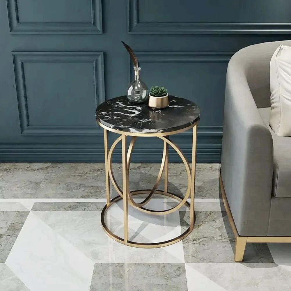 Rounded gold side table with a black marble top