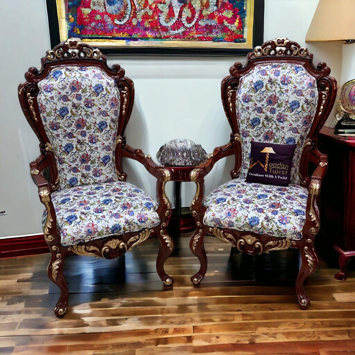 Hand-carved teak armchairs with golden leaf armrests