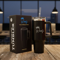 A cinematic lifestyle shot of a premium 40oz insulated stainless steel tumbler in a soft peach-pink color. A woman is holding the tumbler while sitting in the driver's seat of a car at night, with city lights blurred in the background. The tumbler features a sturdy handle, a clear lid with a reusable straw, and the "Raafi" brand logo engraved on the side.