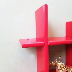 Criss Cross Floating Wall Shelf wall mounted above a sofa